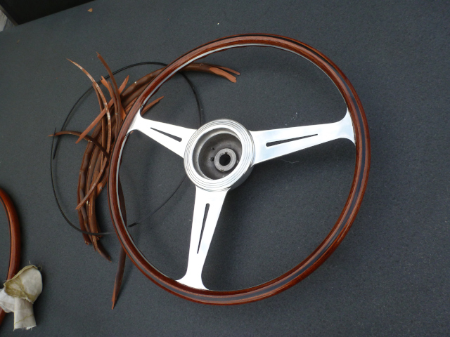 Restored steering wheel next to the remains of the original wood