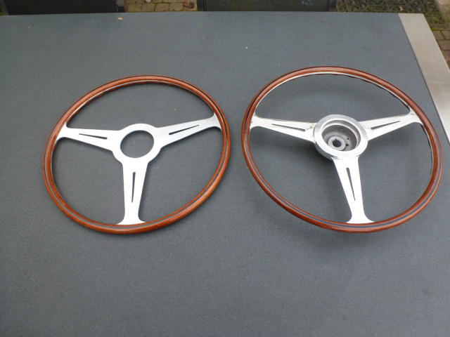 The restored steering wheel next to a newly made copy