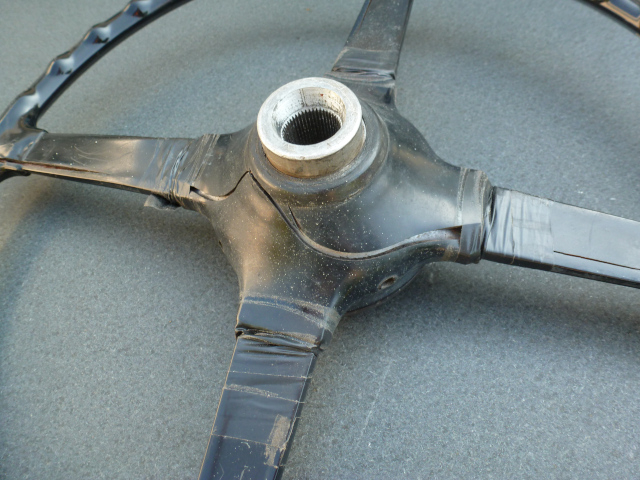 Steering wheel before restoration with lots of cracks