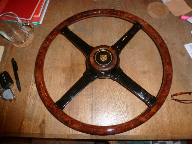 Restored steering wheel with Burl walnut rim and plastic replaced by epoxy. Special horn button with inlaid wood