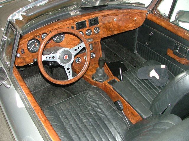 Steering wheel, dashboard, center console made of ply wood and covered with Burl walnut veneer