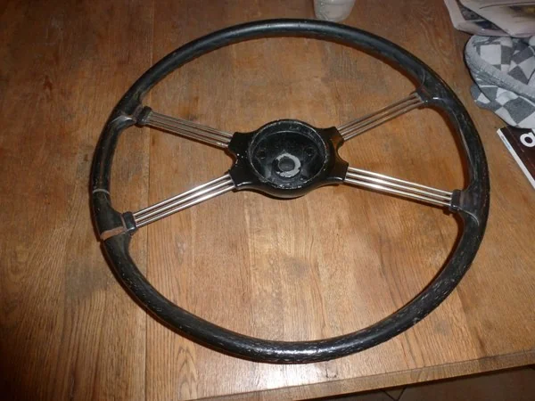 MGA steering wheel before restoration with hub repainting and spoke polishing
