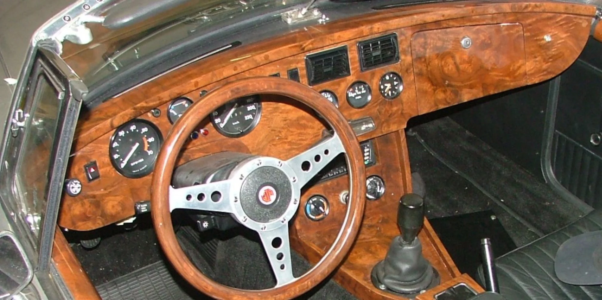 Handcrafted classic wooden dashboard and steering wheel